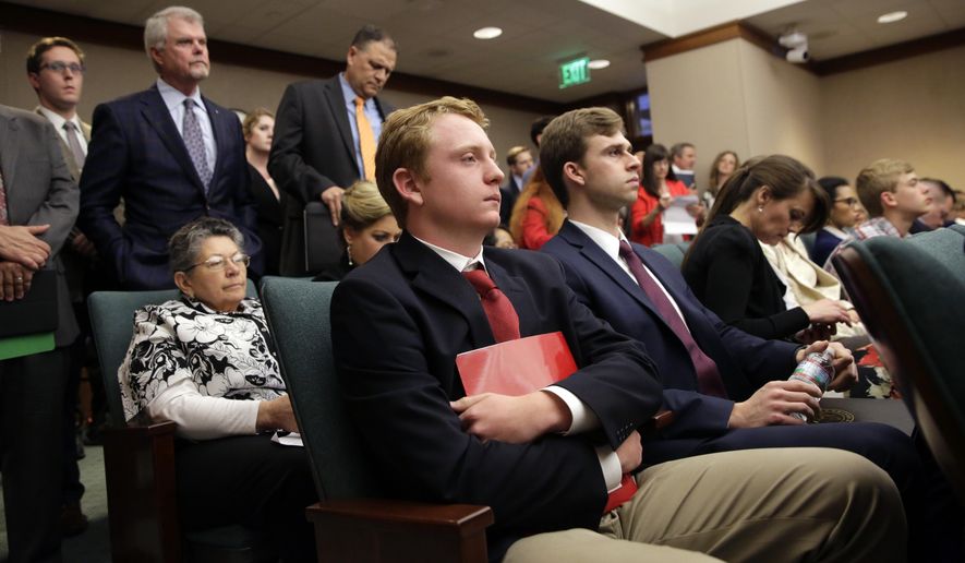 Jacob Hale, 17, center, waits to testify at the Texas Capitol in support of a bill before the House State Affairs committee to renew his effort to eliminate a state holiday honoring Confederate heroes with new backing from a high-powered lobbying firm, Wednesday, April 17, 2019, in Austin, Texas. Hale says it is important to remember the past in an accurate, truthful way that reflects Texas' values. (AP Photo/Eric Gay)