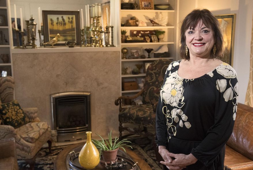 In this Thursday, April 4, 2019 photo, Deb Arends poses at her home in Lincoln, Neb. Deb Arends knows a lot about bats. She knows that a single bat can eat a thousand mosquitoes in an hour, that they eat the mosquitoes in flight. She knows bats have to drop to fly, which is why they hang on to the side of the house, getting ready to drop and fly. And Arends knows exactly how it feels to wake up with a bat in your bed. (Gwyneth Roberts/Lincoln Journal Star via AP)