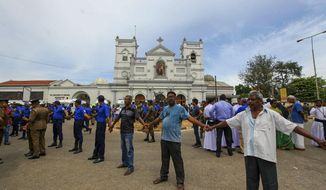 Sri Lankan army soldiers secure the area around St. Anthony&#39;s Shrine after a blast in Colombo, Sri Lanka, Sunday, April 21, 2019. More than hundred people were killed and hundreds more hospitalized from injuries in near simultaneous blasts that rocked three churches and three luxury hotels in Sri Lanka on Easter Sunday, a security official told The Associated Press, in the biggest violence in the South Asian country since its civil war ended a decade ago. (AP Photo/ Rohan Karunarathne )