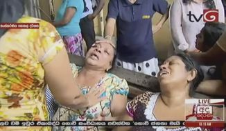This image made from video, released by Derena TV shows women in despair after an explosion in Colombo, Sunday, April 21, 2019. Witnesses are reporting two explosions have hit two churches in Sri Lanka on Easter Sunday, causing casualties among worshippers.(Derena TV via AP)