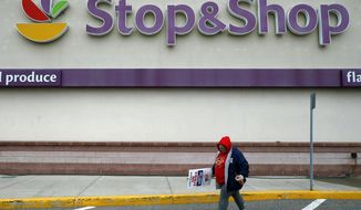 FILE - In this Thursday, April 18, 2019, file photo, a striking worker walks outside a Stop &amp;amp; Shop supermarket in Revere, Mass. Stop &amp;amp; Shop supermarket workers and company officials said Sunday, April 21 they&#x27;ve reached a tentative contract agreement. (AP Photo/Michael Dwyer, File)
