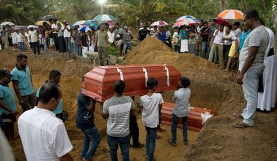 Relatives carry a coffin for burial during the funerals of three members of the same family, all died at Easter Sunday bomb blast at St. Sebastian Church in Negombo, Sri Lanka, Monday, April 22, 2019. Easter Sunday bombings of churches, luxury hotels and other sites was Sri Lanka&#39;s deadliest violence since a devastating civil war in the South Asian island nation ended a decade ago. (AP Photo/Gemunu Amarasinghe)