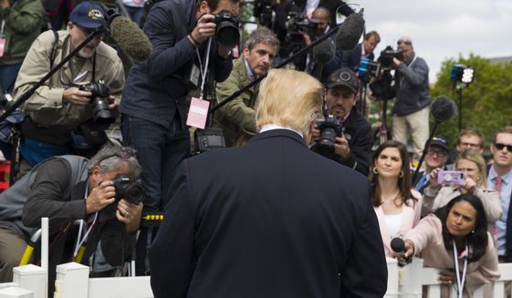 President Donald Trump stops to answer a few questions from the media on the South Lawn of the White House in Washington, Monday, April 22, 2019, during the annual White House Easter Egg Roll. (AP Photo/Alex Brandon)