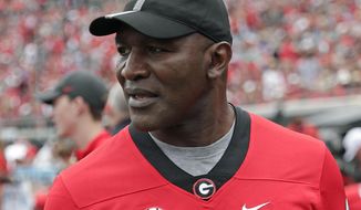 FILE - In this Oct. 27, 2019, file photo, former professional boxer Evander Holyfield paces the sidelines as he watches his son, Georgia running back Elijah Holyfield, play in an NCAA college football game against Florida, in Jacksonville, Fla. Elijah Holyfield says it wasn&#39;t an easy decision to leave Georgia after his junior season. (AP Photo/John Raoux, File)