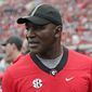 FILE - In this Oct. 27, 2019, file photo, former professional boxer Evander Holyfield paces the sidelines as he watches his son, Georgia running back Elijah Holyfield, play in an NCAA college football game against Florida, in Jacksonville, Fla. Elijah Holyfield says it wasn&#x27;t an easy decision to leave Georgia after his junior season. (AP Photo/John Raoux, File)