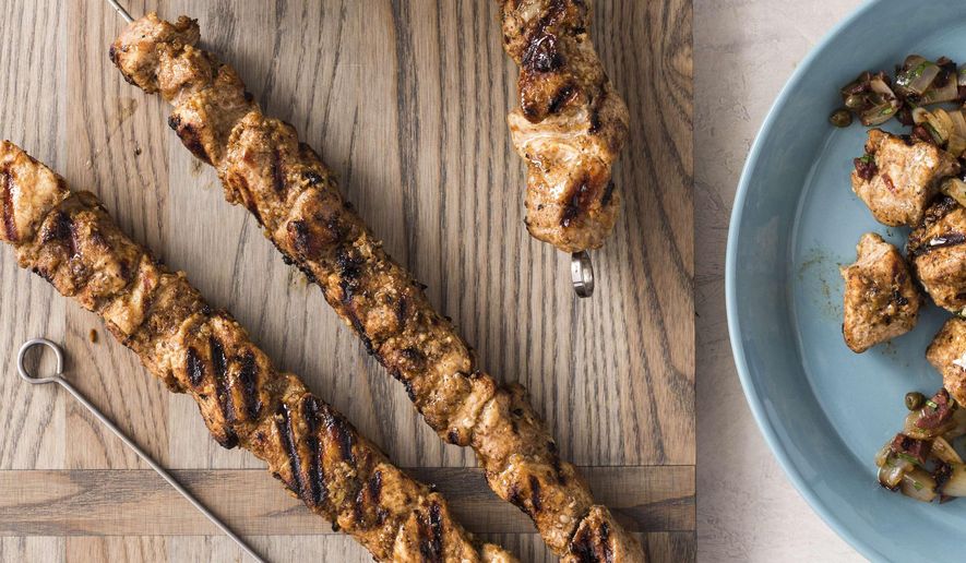 This undated photo provided by America's Test Kitchen in April 2019 shows Grilled Spiced Pork Skewers with Onion and Caper Relish in Brookline, Mass. This recipe appears in "The Complete Diabetes Cookbook." (Joe Keller/America's Test Kitchen via AP)