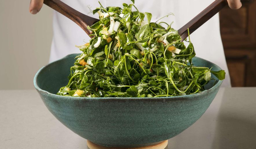 This undated photo provided by America's Test Kitchen in April 2019 shows a Pea Green Salad with Warm Apricot-Pistachio Vinaigrette in Brookline, Mass. This recipe appears in the cookbook "Vegetables Illustrated." (Daniel J. van Ackere/America's Test Kitchen via AP)