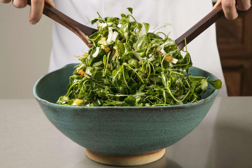 This undated photo provided by America's Test Kitchen in April 2019 shows a Pea Green Salad with Warm Apricot-Pistachio Vinaigrette in Brookline, Mass. This recipe appears in the cookbook "Vegetables Illustrated." (Daniel J. van Ackere/America's Test Kitchen via AP)