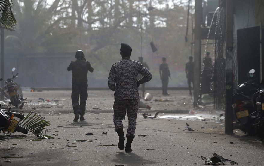 Sri Lankan security forces approach the site after a vehicle parked near St. Anthony's shrine exploded in Colombo, Sri Lanka, Monday, April 22, 2019. Easter Sunday bombings that ripped through churches and luxury hotels killed more than 200 people.(AP Photo/Eranga Jayawardena)