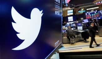 The logo for Twitter is displayed above a trading post on the floor of the New York Stock Exchange. (AP Photo/Richard Drew, File)