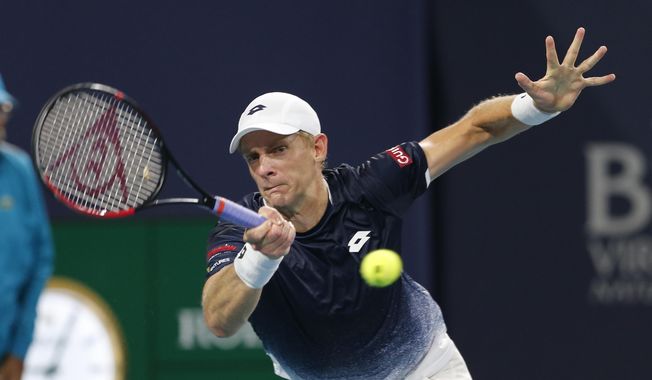 FILE - In this March 28, 2019, file photo, Kevin Anderson, of South Africa, hits a forehand to Roger Federer, of Switzerland, during a quarterfinal match at the Miami Open tennis tournament, in Miami Gardens, Fla. Two-time Grand Slam runner-up Kevin Anderson is skipping the clay-court swing this season because of a lingering right elbow injury. Anderson announced Tuesday, April 23, 2019, via a post on Twitter that he is withdrawing from the French Open, as well as tuneup tournaments in Estoril, Madrid and Rome. (AP Photo/Joe Skipper, File)