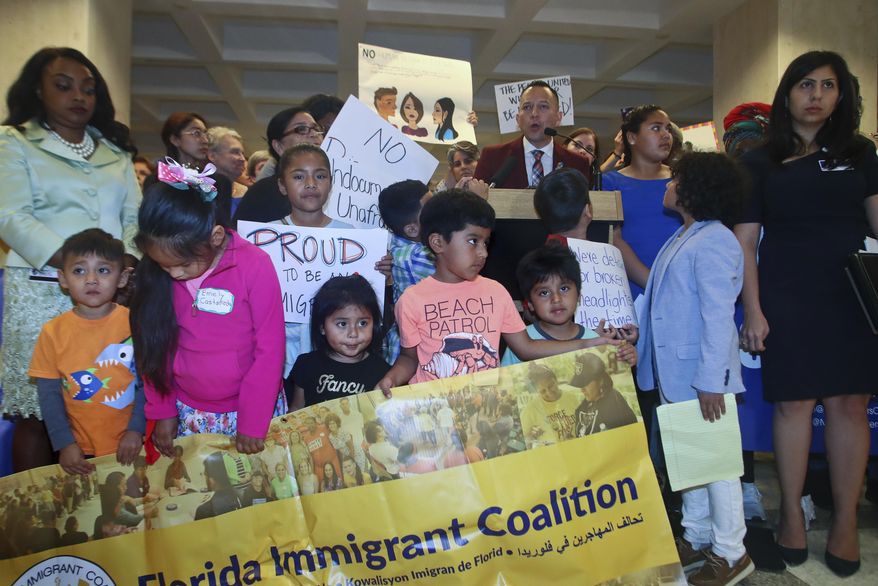 Top right, Rep. Carlos Guillermo Smith (D-Orlando) speaks out against Family Separation Bills HB 527 and SB 168 Tuesday, April 23, 2019, during a press conference in the Florida Capitol in Tallahassee, Fla. (AP Photo/Phil Sears)