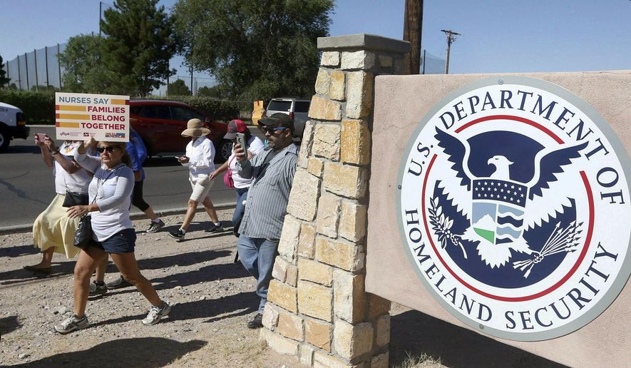 FILE - This June 2018 file photo shows protesters walking along Montana Avenue outside the El Paso Processing Center, in El Paso, Texas. On Tuesday, April 23, 2019, a U.S. government watchdog agency said they have launched an investigation in the wake of an Associated Press report revealing complaints about how immigration authorities treated hunger strikers at this facility. (Rudy Gutierrez/The El Paso Times via AP, File)