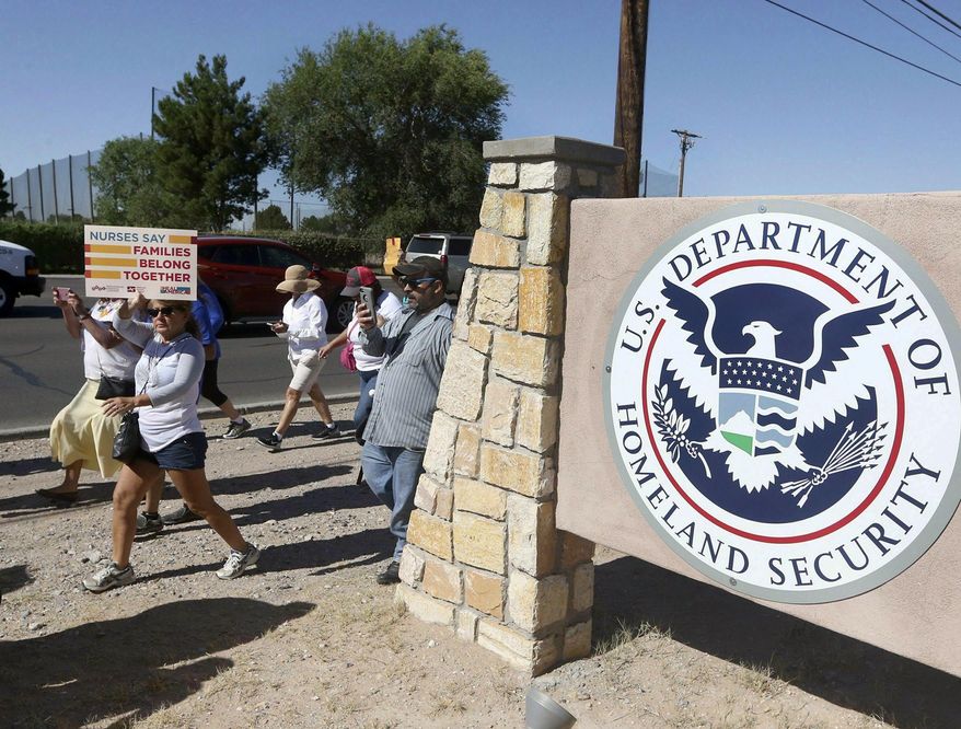 FILE - This June 2018 file photo shows protesters walking along Montana Avenue outside the El Paso Processing Center, in El Paso, Texas. On Tuesday, April 23, 2019, a U.S. government watchdog agency said they have launched an investigation in the wake of an Associated Press report revealing complaints about how immigration authorities treated hunger strikers at this facility. (Rudy Gutierrez/The El Paso Times via AP, File)