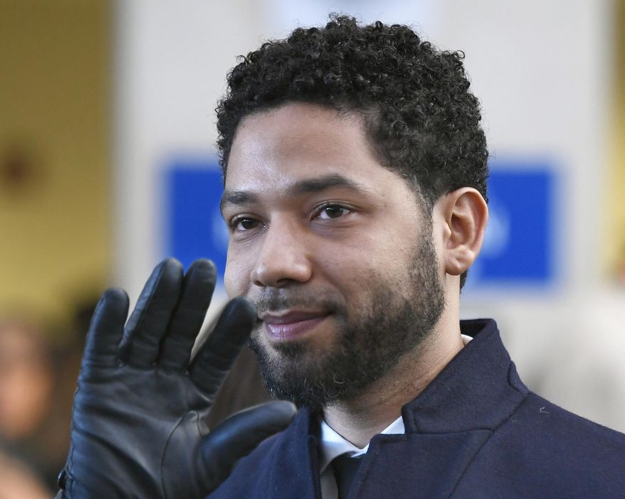 In this March 26, 2019, file photo, actor Jussie Smollett smiles and waves to supporters before leaving Cook County Court after his charges were dropped in Chicago. (Associated Press)