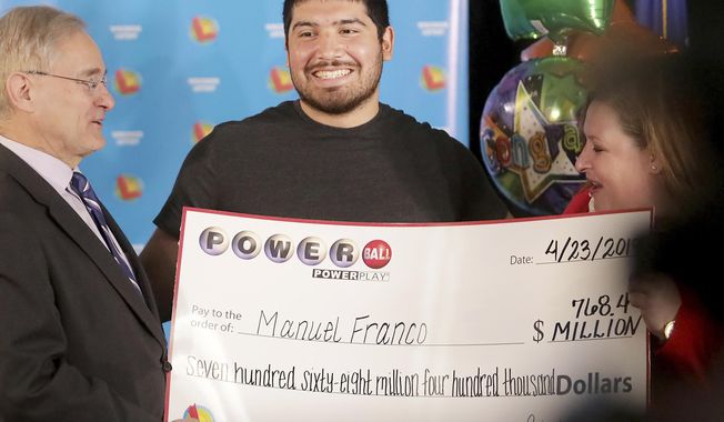 Manuel Franco of West Allis, Wis., winner of second-highest Powerball lottery in history, attends a news conference at the Wisconsin Department of Revenue in Madison, Wis., on Tuesday, April 23, 2019. At right is Peter Barca, state secretary of revenue, and at right is Cindy Polzin, state lottery director. Franco claimed the cash option payout of the prize, totaling approximately $477 million before taxes. The overall jackpot of the prize, drawn March 22, was $768,400. (John Hart/Wisconsin State Journal via AP)