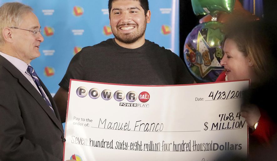 Manuel Franco of West Allis, Wis., winner of second-highest Powerball lottery in history, attends a news conference at the Wisconsin Department of Revenue in Madison, Wis., on Tuesday, April 23, 2019. At right is Peter Barca, state secretary of revenue, and at right is Cindy Polzin, state lottery director. Franco claimed the cash option payout of the prize, totaling approximately $477 million before taxes. The overall jackpot of the prize, drawn March 22, was $768,400. (John Hart/Wisconsin State Journal via AP)
