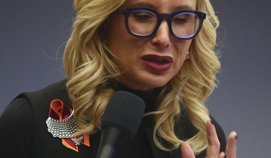 Sen. Lauren Book, D-Plantation, holds back tears as she talks about the shooting victims while debating Senate Bill 7030: Implementation of Legislative Recommendations of the Marjory Stoneman Douglas High School Public Safety Commission, Tuesday, April 23, 2019, in the Florida Senate in Tallahassee, Fla. The bill passed 22-17. (AP Photo/Phil Sears)
