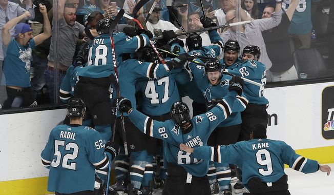 San Jose Sharks players celebrate after defeating the Vegas Golden Knights in Game 7 of an NHL hockey first-round playoff series in San Jose, Calif., Tuesday, April 23, 2019. The Sharks won 5-4 in overtime. (AP Photo/Jeff Chiu)