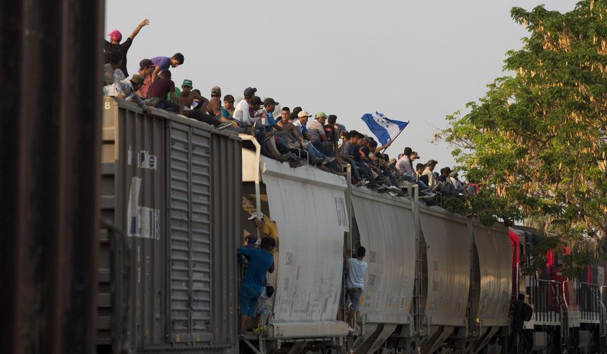 Central American migrants ride atop a freight train during their journey toward the U.S.-Mexico border, in Ixtepec, Oaxaca State, Mexico, Tuesday, April 23, 2019. The once large caravan of about 3,000 people was essentially broken up by an immigration raid on Monday, as migrants fled into the hills, took refuge at shelters and churches or hopped passing freight trains. (AP Photo/Moises Castillo)