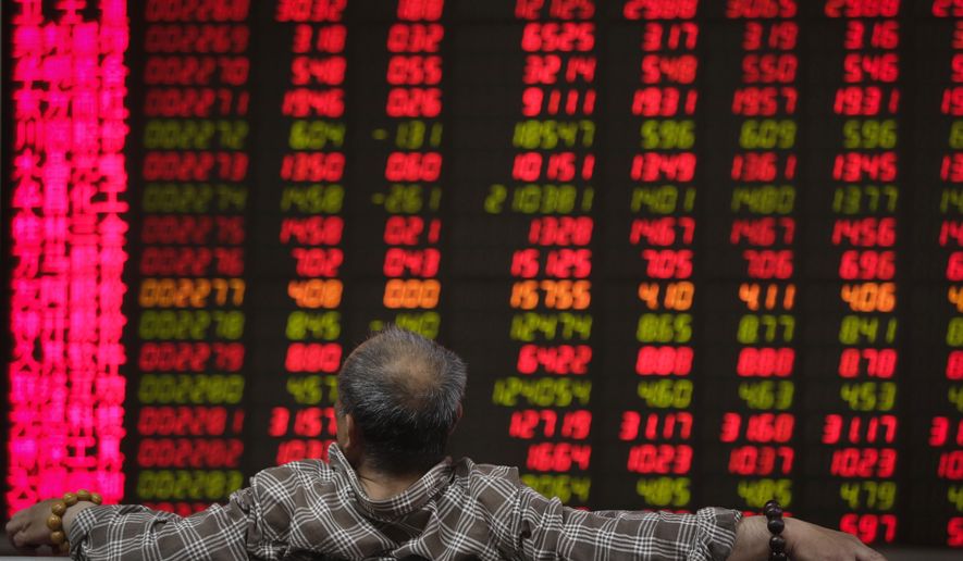 A man looks at an electronic board displaying stock prices at a brokerage house in Beijing, Wednesday, April 24, 2019. Shares were mostly lower in Asia on Wednesday despite the S&P 500’s all-time record high close the day before. (AP Photo/Andy Wong)