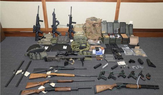 This file image provided by the U.S. District Court in Maryland shows a photo of firearms and ammunition that was in the motion for detention pending trial in the case against Christopher Paul Hasson. Hasson, a Coast Guard lieutenant accused of stockpiling guns and compiling a hit list of prominent Democrats and network TV journalists looked at other targets: two Supreme Court justices and two executives of social media companies, according to federal prosecutors in a court filing Tuesday, April 22, 2019. (U.S. District Court via AP) **FILE**
