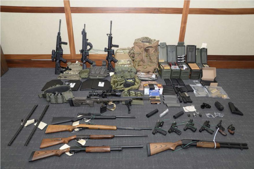 This file image provided by the U.S. District Court in Maryland shows a photo of firearms and ammunition that was in the motion for detention pending trial in the case against Christopher Paul Hasson. Hasson, a Coast Guard lieutenant accused of stockpiling guns and compiling a hit list of prominent Democrats and network TV journalists looked at other targets: two Supreme Court justices and two executives of social media companies, according to federal prosecutors in a court filing Tuesday, April 22, 2019. (U.S. District Court via AP) **FILE**