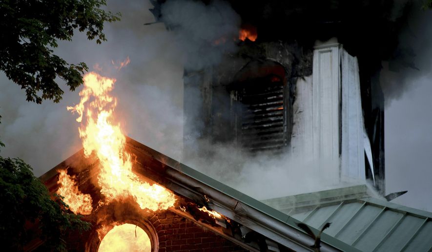 In this Tuesday, April 23, 2019, photo flames rise from a fire at the Loudon County Courthouse, one of the oldest courthouses in Tennessee, in Loudon, Tenn. The fire caused significant damage to the courthouse. (Calvin Mattheis/Knoxville News Sentinel via AP)