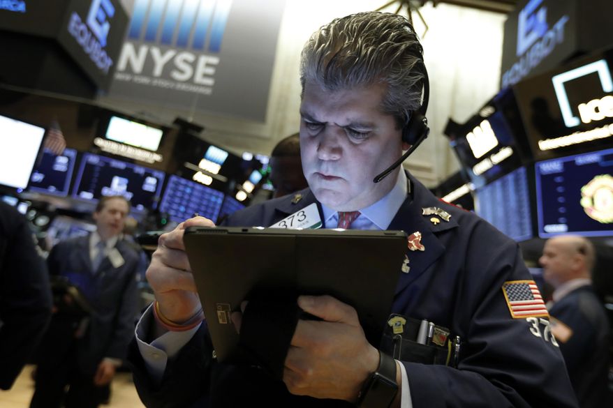 FILE - In this Feb. 5, 2019, file photo, trader John Panin works on the floor of the New York Stock Exchange. On Wednesday, April 24, stocks are opening slightly lower on Wall Street, a day after the S&P 500 surpassed the record high close it set in September. (AP Photo/Richard Drew, File)