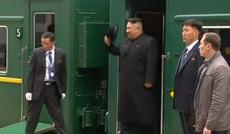 In this image taken from the RU-RTR Russian television, North Korean leader Kim Jong Un smiles as he leaves a train in Vladivostok railway station in Vladivostok, Russia, Wednesday, April 24, 2019. North Korean leader Kim Jong Un arrived in Russia by train on Wednesday, a day before his much-anticipated summit with President Vladimir Putin that comes amid deadlocked diplomacy on his nuclear program. (RU-RTR Russian Television via AP)