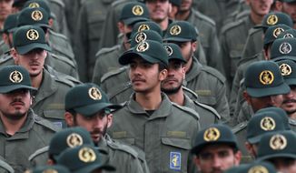 In this Feb. 11, 2019, file photo, Iranian Revolutionary Guard members attend a ceremony celebrating the 40th anniversary of the Islamic Revolution, at the Azadi, or Freedom, Square in Tehran, Iran. The Trump administration on Wednesday granted important exemptions to new sanctions on Iran’s Revolutionary Guard, watering down the effects of the measures while also eliminating an aspect that would have complicated U.S. foreign policy efforts.  (AP Photo/Vahid Salemi)