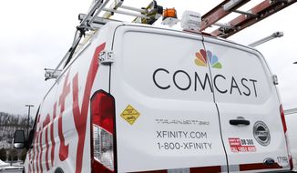 This Jan. 24, 2019, file photo shows a Comcast truck in Pittsburgh. Comcast Corp. reports earns on Thursday, April 25. (AP Photo/Gene J. Puskar, File)