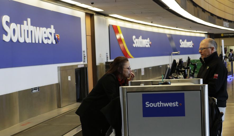 FILE - In this March 13, 2019, file photo a traveler checks in with Southwest Airlines at Seattle-Tacoma International Airport in Seattle. Southwest Airlines Co. reports earns on Thursday, April 25. (AP Photo/Ted S. Warren, File)