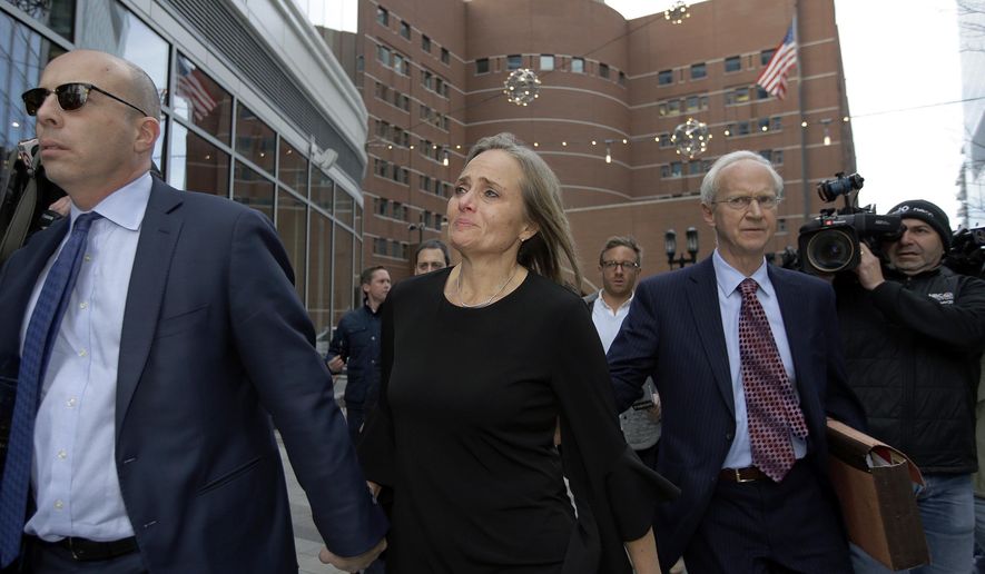 District Court Judge Shelley M. Richmond Joseph, center, departs federal court, Thursday, April 25, 2019, in Boston after facing obstruction of justice charges for allegedly helping a man in the country illegally evade immigration officials as he left her Newton, Mass., courthouse after a hearing in 2018. (AP Photo/Steven Senne)