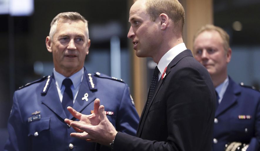 Britain's Prince William, center, meets with Police St. Johns ambulance staff during a visit to the Justice and Emergency Services Precinct in Christchurch, New Zealand, Thursday, April 25, 2019. Prince William is on a two-day visit to New Zealand to take part in ANZAC ceremonies and visit the two mosques where a gunman killed 50 people on March 15. (Rosa Woods/Pool Photo via AP)