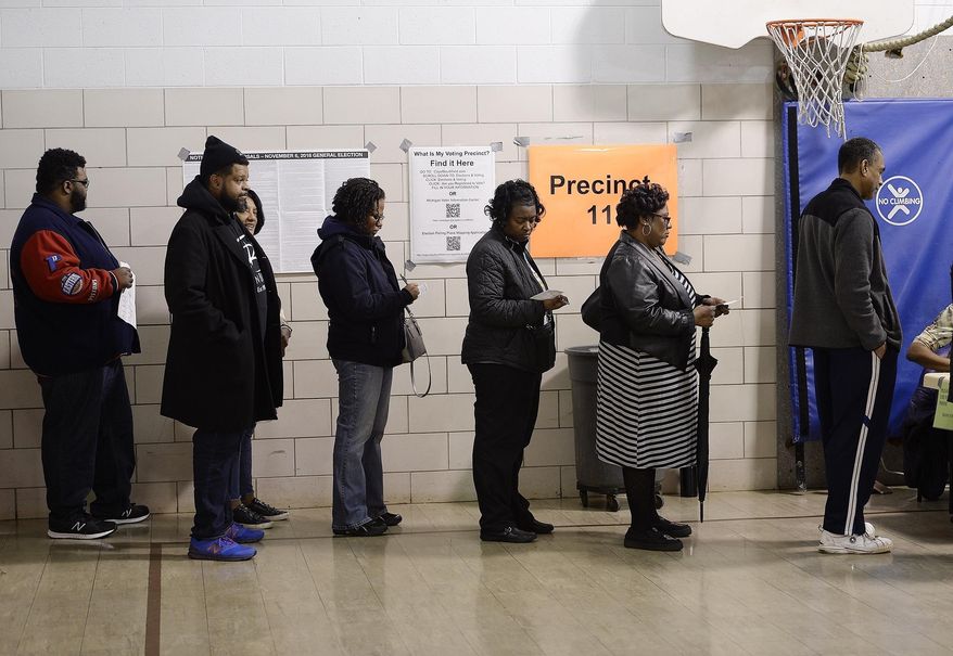 FILE- In a Nov. 6, 2018 file photo voters wait in line on election day in Southfield, Mich. A three-judge panel has ruled that Michigan's congressional and legislative maps are unconstitutionally gerrymandered, ordering the state Legislature to redraw at least 34 districts for the 2020 election. The decision issued Thursday, April 25, 2019, also requires special state Senate elections to be held in 2020, instead of 2022 as scheduled. The judges say the maps drawn by Republicans in 2011 violate Democratic voters' constitutional rights.(Clarence Tabb, Jr /Detroit News via AP, File)