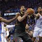Portland Trail Blazers center Enes Kanter, center, Oklahoma City Thunder forward Jerami Grant, left, and guard Terrance Ferguson, right, compete for a rebound in the second half of Game 4 of an NBA basketball first-round playoff series Sunday, April 21, 2019, in Oklahoma City. Portland won 111-98. (AP Photo/Alonzo Adams) **FILE**