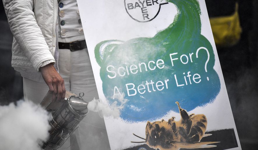Protestors demonstrate against Monsanto outside the annual general meeting of Bayer AG in Bonn, Germany, Friday, April 26, 2019. Following the record acquisition of U.S. biotech and seed company Monsanto, Bayer's agricultural business has become a risk for the German chemical company. Bayer is facing enormous cost if the U.S. court will find Monsanto's glyphosate to be causing cancer. Since the take-over of Monsanto in June 2018, Bayer lost around half of its value in market capitalization. (AP Photo/Martin Meissner)