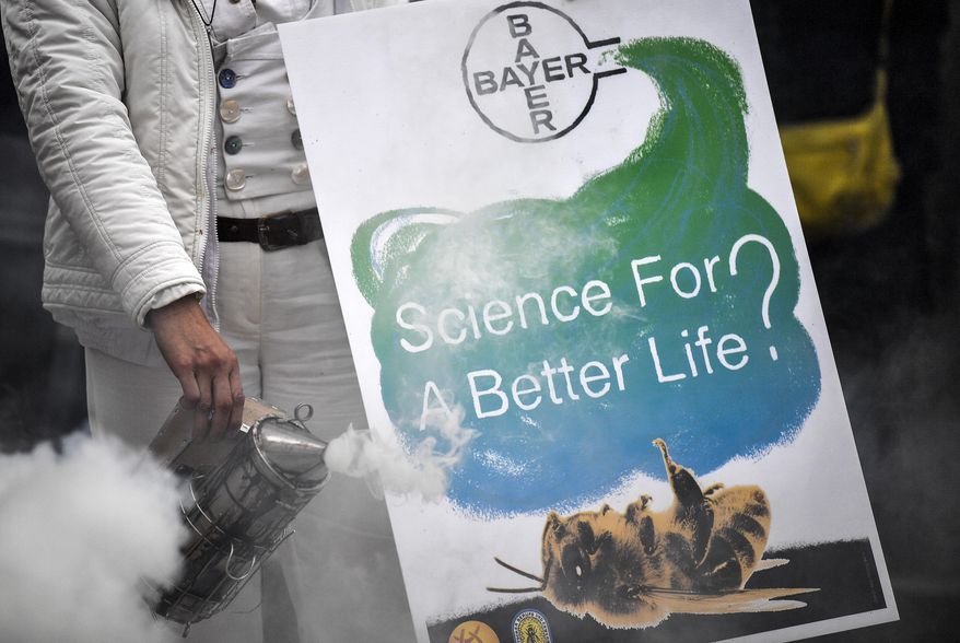 Protestors demonstrate against Monsanto outside the annual general meeting of Bayer AG in Bonn, Germany, Friday, April 26, 2019. Following the record acquisition of U.S. biotech and seed company Monsanto, Bayer's agricultural business has become a risk for the German chemical company. Bayer is facing enormous cost if the U.S. court will find Monsanto's glyphosate to be causing cancer. Since the take-over of Monsanto in June 2018, Bayer lost around half of its value in market capitalization. (AP Photo/Martin Meissner)