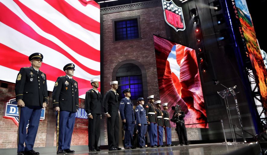 Members of the U.S. military stand on stage during the third round of the NFL football draft, Friday, April 26, 2019, in Nashville, Tenn. (AP Photo/Mark Humphrey)