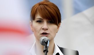 FILE - In this April 21, 2013 file photo, Maria Butina, leader of a pro-gun organization in Russia, speaks to a crowd during a rally in support of legalizing the possession of handguns in Moscow, Russia.  (AP Photo/File)