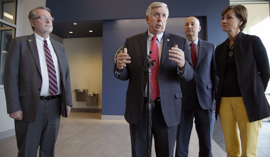 Iowa Gov. Kim Reynolds, right, Nebraska Gov. Pete Ricketts, second right, Missouri Gov. Mike Parson, and Kansas Lt. Gov. Lynn Rogers, left, face reporters following a meeting in Council Bluffs, Iowa, Friday, April 26, 2019, with officials from the U.S. Army Corps of Engineers and the Federal Emergency Management Agency to discuss the aftermath of the recent flooding along the Missouri River. (AP Photo/Nati Harnik)