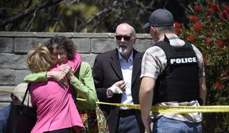 Two people hug as another talks to a San Diego County Sheriff&#39;s deputy outside of the Chabad of Poway Synagogue Saturday, April 27, 2019, in Poway, Calif. Several people have been shot and injured at a synagogue in San Diego, California, on Saturday, said San Diego County authorities. (AP Photo/Denis Poroy)