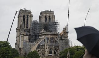 Cranes work at Notre Dame cathedral, in Paris, Thursday, April 25, 2019. French police scientists were starting to examine Notre Dame Cathedral on Thursday for the first time since last week&#39;s devastating fire. (AP Photo/Thibault Camus)