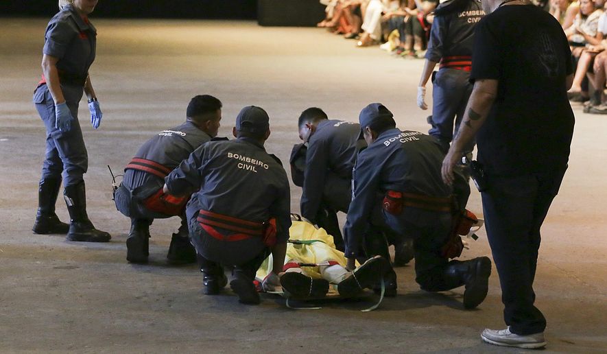 Model Tales Soares is taken from the catwalk by paramedics after he collapsed during Sao Paulo Fashion Week in Sao Paulo, Brazil, Saturday, April 27, 2019. A statement from organizers said that Soares died after taking ill while participating in the Sao Paulo's Fashion Week. (Leco Viana/Thenews2 via AP)