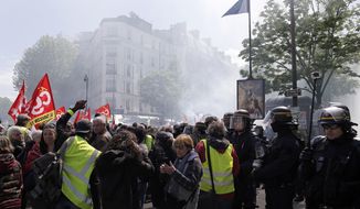 Yellow Vest demonstrators gather in Paris, during another protest Saturday April 27, 2019. Yellow vest protesters remain a force in French politics despite ups and downs in the five months after their movement started. (AP Photo/Rafael Yaghobzadeh)