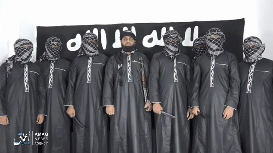 This undated image posted by the Islamic State group's Aamaq news agency on Tuesday, April 23, 2019, purports to show Mohammed Zahran, a.k.a. Zahran Hashmi, center, the man Sri Lanka says led the Easter attack that killed over 300 people, as well as other attackers. Sri Lankan authorities have blamed the militant Muslim group National Thowfeek Jamaath for the attack. The Islamic State group released the photo Tuesday to assert its claim on the assault. (Aamaq news agency via AP)