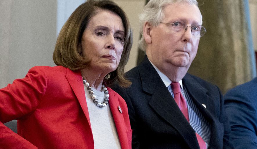 In this March 21, 2018, file photo Nancy Pelosi of Calif.,  and Senate Majority Leader Mitch McConnell of Ky., attend a Congressional Gold Medal Ceremony honoring the Office of Strategic Services in Emancipation Hall on Capitol Hill in Washington. Pelosi and McConnell are coming together to see if a deal can be made to stop billions of dollars in government spending cuts. Failure to reach an agreement would usher in cuts to the Pentagon and domestic programs of $125 billion next year _ a 10 percent drop from current levels.(AP Photo/Andrew Harnik, File)