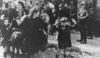 In this April 19, 1943, file photo, a group of Jews is escorted from the Warsaw Ghetto by German soldiers. After a year of tough negotiations, Germany agreed Monday, Dec. 5, 2011, to pay pensions to about 16,000 Holocaust victims worldwide who survived wartime ghettos or were forced to hide from Nazi persecution. (AP Photo, File)