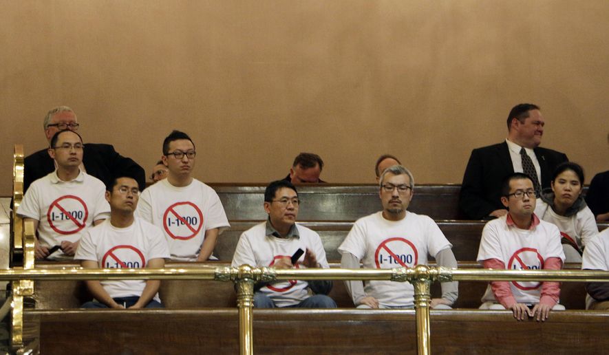 Opponents of an initiative to the Legislature that would allow the state to use hiring and recruitment goals, but not quotas, to bring minority candidates into state jobs, education, and contracting sit in the public gallery in the Washington House, on Sunday, April 28, 2019, in Olympia, Wash. The measure loosens restrictions enacted in a separate 1998 initiative that banned government discrimination or preferential treatment based on factors like race or gender. (AP Photo/Rachel La Corte)